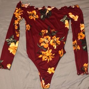 Burgundy body shirt with yellow followers and a v cut in the middle